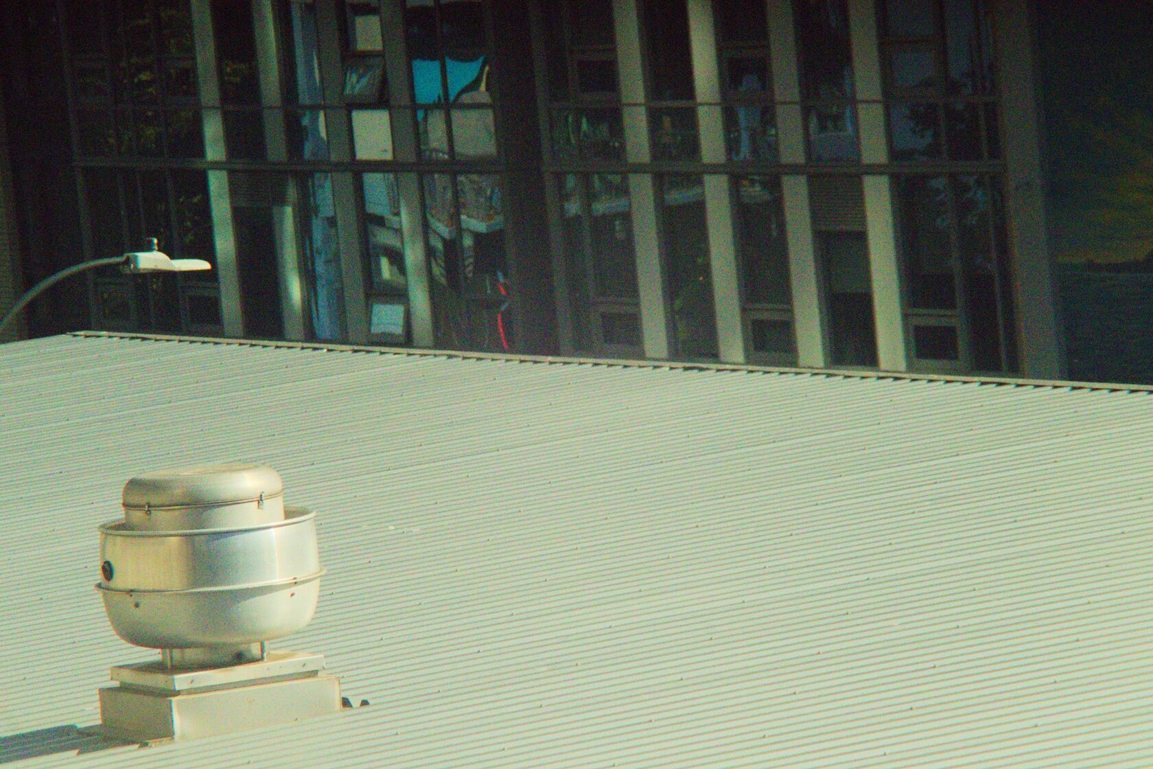 Commercial HVAC technician working on rooftop unit